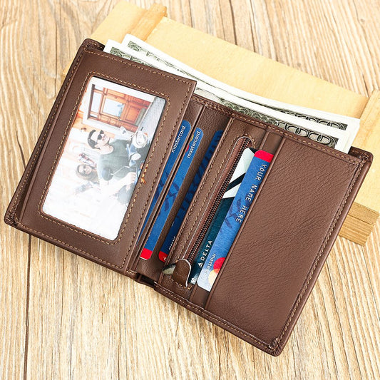 Brown leather wallet with cards and money on a wooden surface