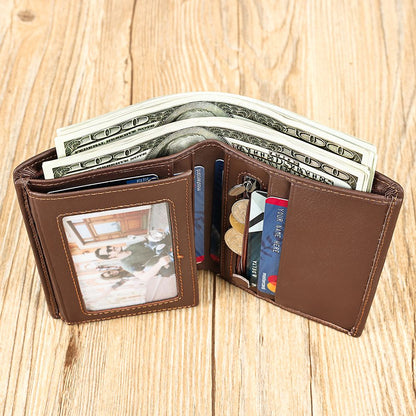 Brown wallet with money, cards, and a photo on a wooden surface